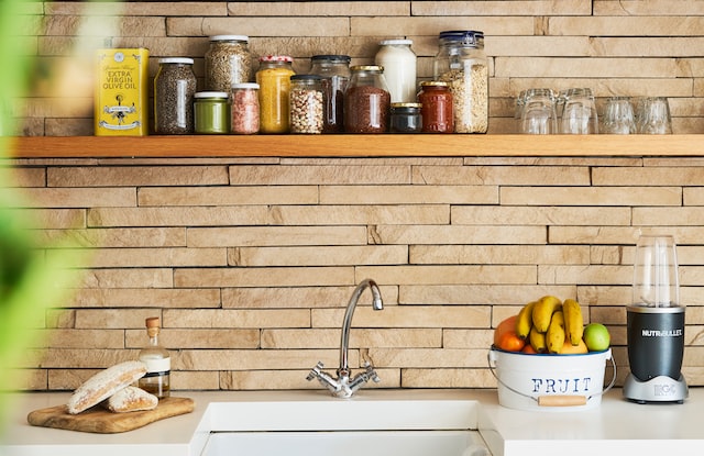 bread and fruits near the faucet in the kitchen