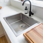kitchen drain with black faucet