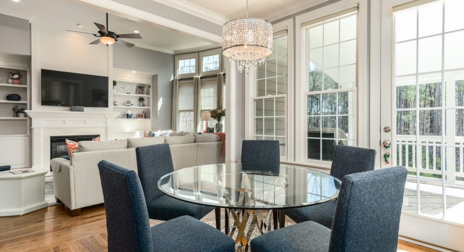round-clear-glass-top-table-and-five-gray-chairs-dining