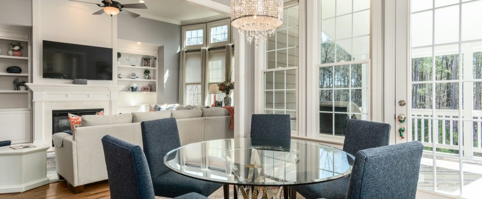 round-clear-glass-top-table-and-five-gray-chairs-dining